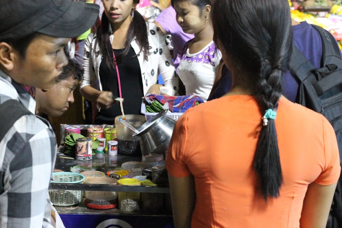 Crowd around a woman at a Betel Nut stand
